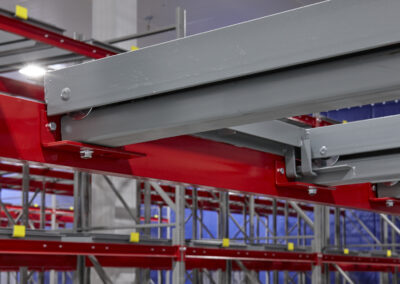 Close-up of a cleat-mounted front beam in a three-deep pushback racking system at Mars Pet Care, using roll-formed uprights and structural beams in a -25°C freezer.