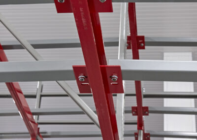 Detailed view of a shared rear beam in a three-deep back-to-back pushback racking configuration at Mars Pet Care, using roll-formed uprights and structural beams in a -25°C freezer.