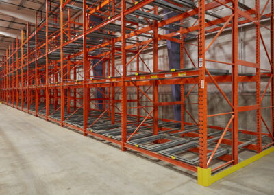 Three-deep pushback racking system against a wall at Home Hardware, roll-formed and four levels high.