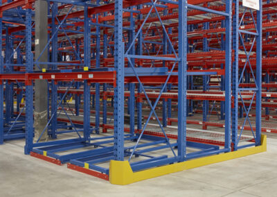 Two-deep back-to-back pushback racking integrated with selective rack at Mevotech, floor-mounted first level, used for auto parts storage with custom pushback colours.